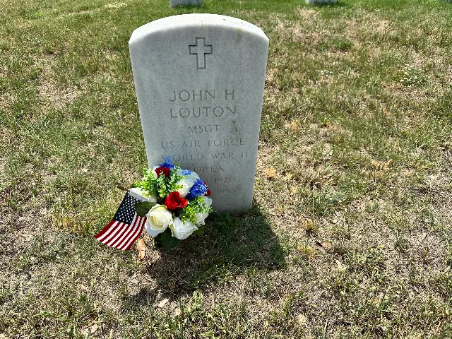 American flag and red, white and blue arrangement at a veteran's grave