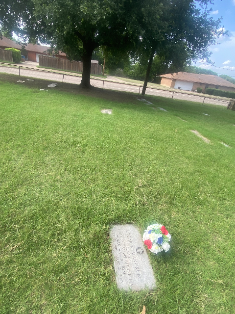 Red roses and blue lilac arrangement at a national veterans cemetery