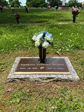 Flowers placed at a grave by a BloomBridge runner