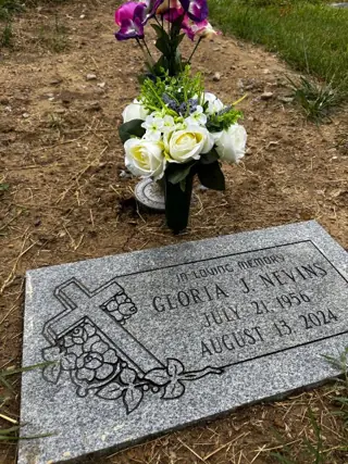 Flowers placed at a grave by a BloomBridge runner